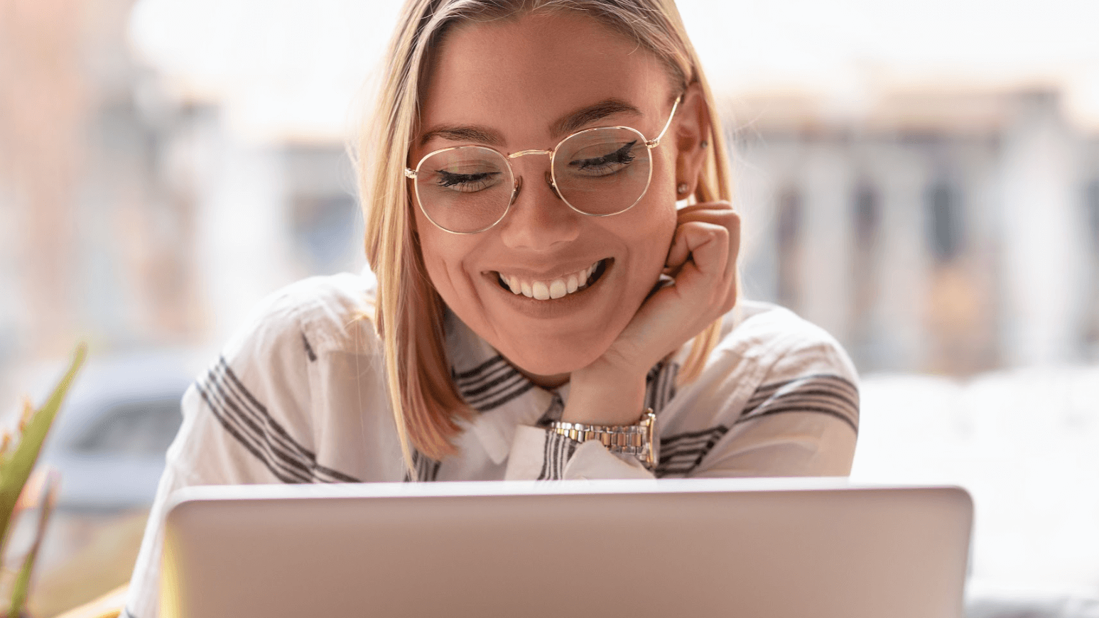 woman in glasses looking at co
